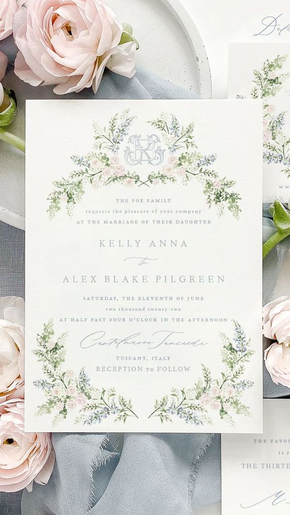 wedding invitation with floral crest monogram on a background with flowers