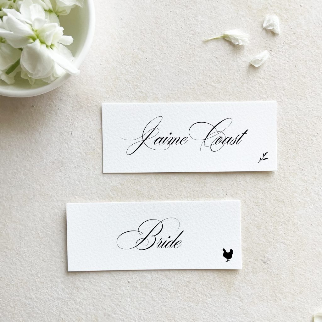thin calligraphy place cards that says "bride" and shows a meal choice with a chicken icon