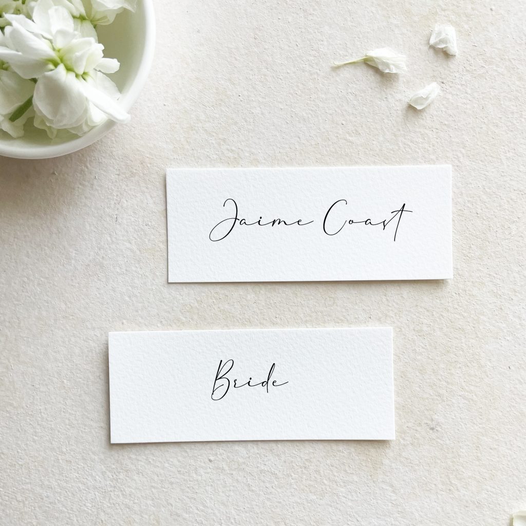 slim place cards with calligraphy that say "jaime coast" and "bride"